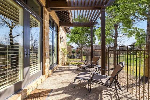 view of patio with a pergola and fence