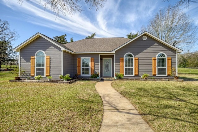 single story home with a front yard and roof with shingles