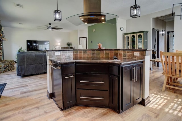 kitchen with a ceiling fan, visible vents, light wood-style floors, pendant lighting, and open floor plan