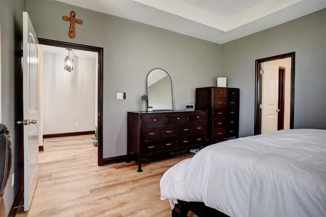 bedroom featuring baseboards and light wood-type flooring