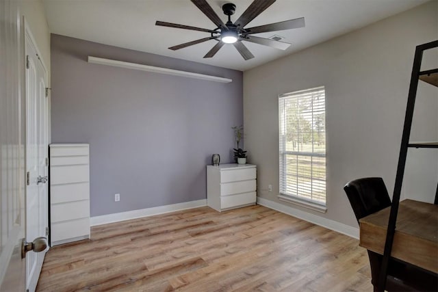 office with light wood-style flooring, baseboards, and a ceiling fan