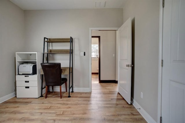 home office with visible vents, baseboards, and wood finished floors