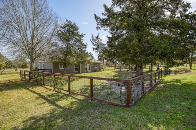 view of yard featuring a rural view and fence