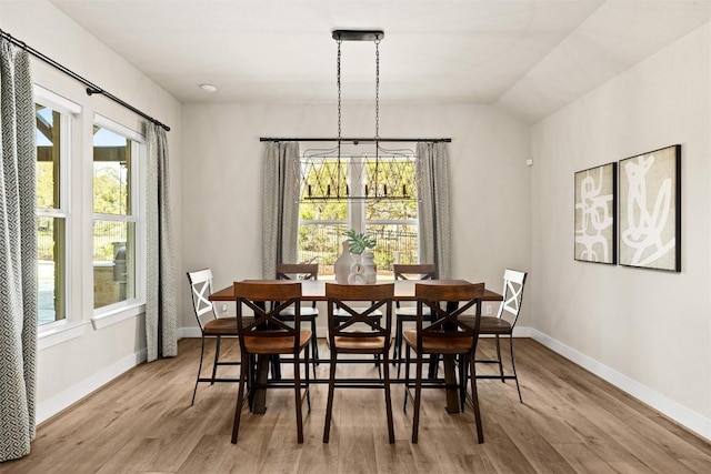 dining space with plenty of natural light, wood finished floors, and baseboards