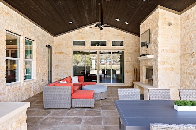 view of patio / terrace featuring outdoor dining space, an outdoor living space with a fireplace, and ceiling fan