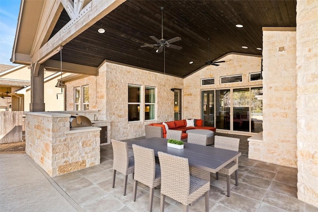 view of patio with an outdoor kitchen, outdoor lounge area, outdoor dining area, and a ceiling fan