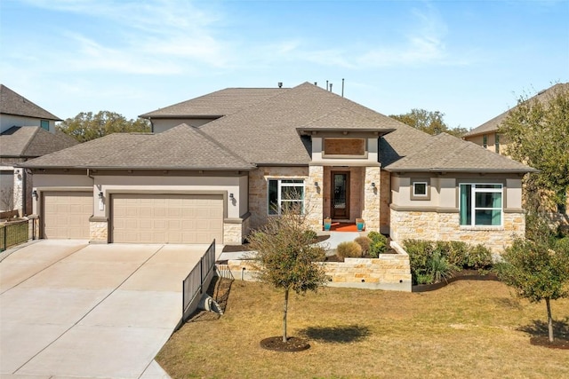 prairie-style home featuring stucco siding, driveway, stone siding, roof with shingles, and a garage