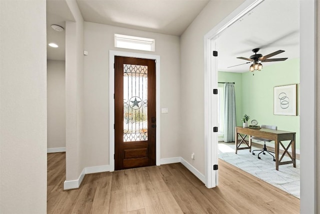 entryway featuring ceiling fan, baseboards, and light wood-style floors