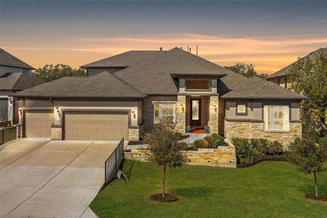 prairie-style home with stone siding, concrete driveway, and an attached garage