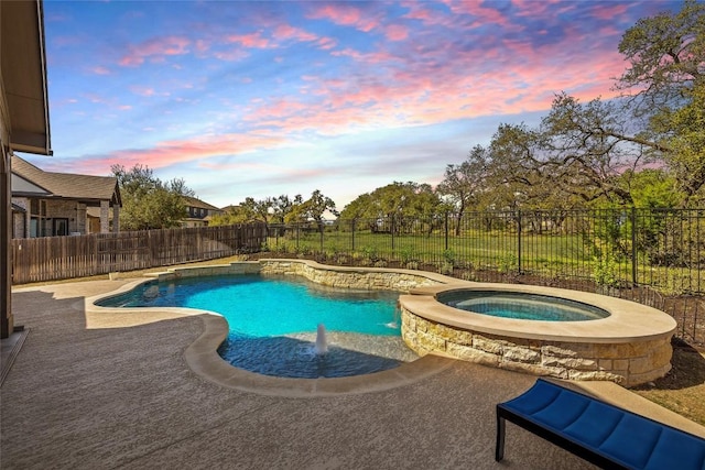view of swimming pool with a fenced backyard and a pool with connected hot tub