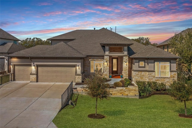 view of front of house with stone siding, driveway, roof with shingles, and an attached garage