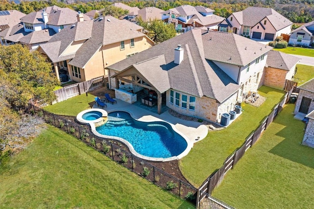 view of swimming pool with a residential view, a pool with connected hot tub, a patio, and cooling unit