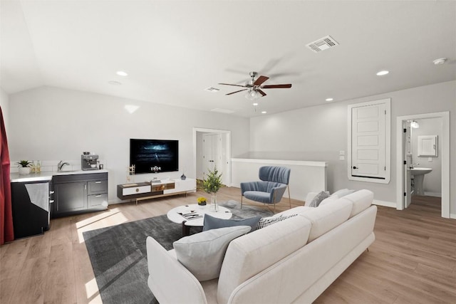 living room featuring ceiling fan, light wood-style floors, recessed lighting, and baseboards