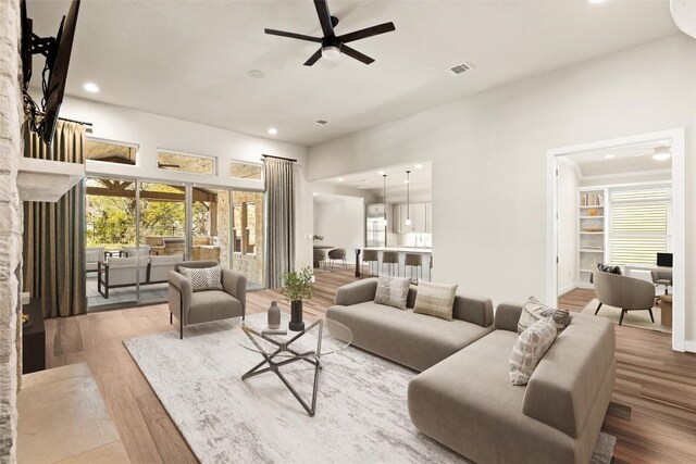 530 Crosswater Ln, Dripping Springs, TX 78620 - living room with ceiling fan, recessed lighting, wood finished floors, and a fireplace