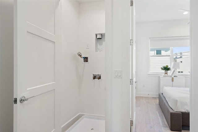 bathroom with baseboards and wood finished floors