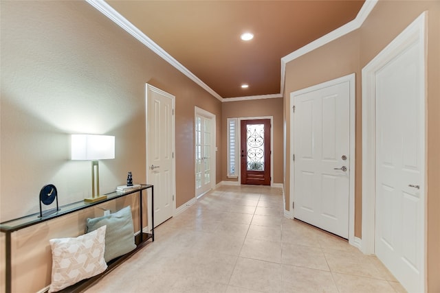 foyer featuring light tile patterned floors, recessed lighting, crown molding, and baseboards