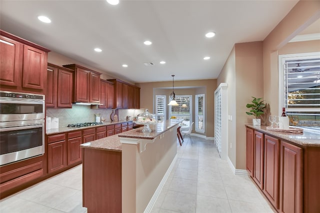 kitchen featuring tasteful backsplash, visible vents, light stone counters, light tile patterned floors, and appliances with stainless steel finishes