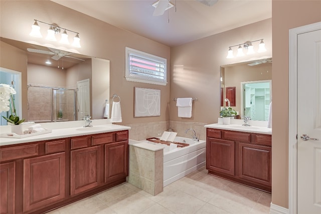 bathroom with tile patterned flooring, a shower stall, ceiling fan, two vanities, and a bath