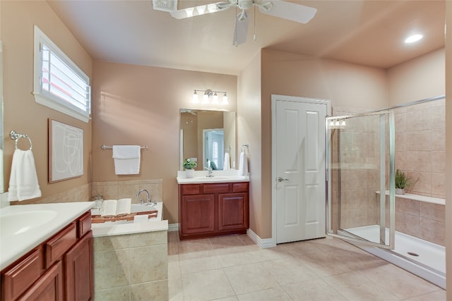 bathroom with two vanities, a stall shower, a sink, tile patterned flooring, and a bath