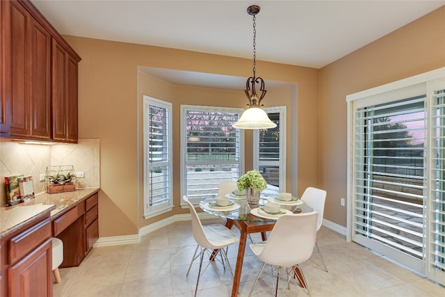 dining room featuring light tile patterned floors and baseboards