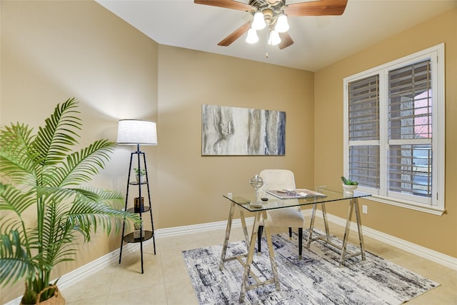 home office with light tile patterned flooring, ceiling fan, and baseboards