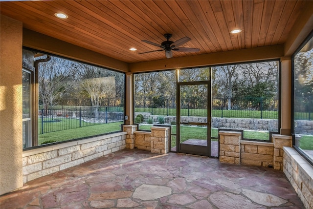 unfurnished sunroom with wooden ceiling and ceiling fan