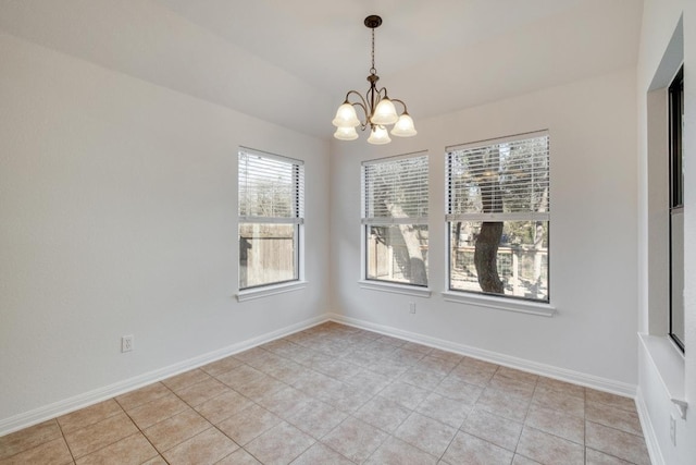 unfurnished room featuring a notable chandelier, baseboards, and light tile patterned floors