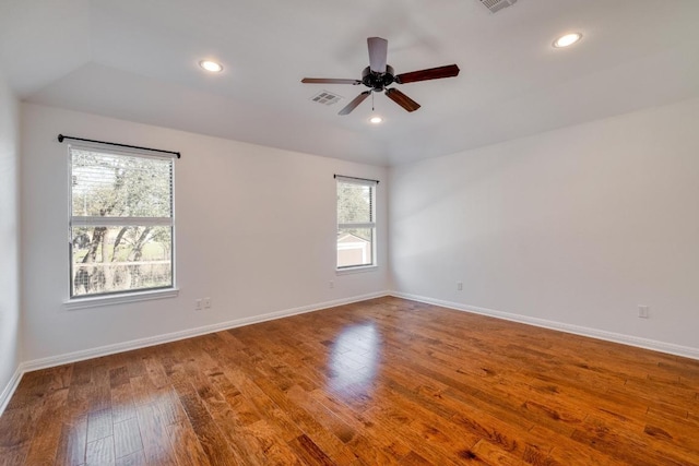 empty room with recessed lighting, baseboards, and hardwood / wood-style flooring