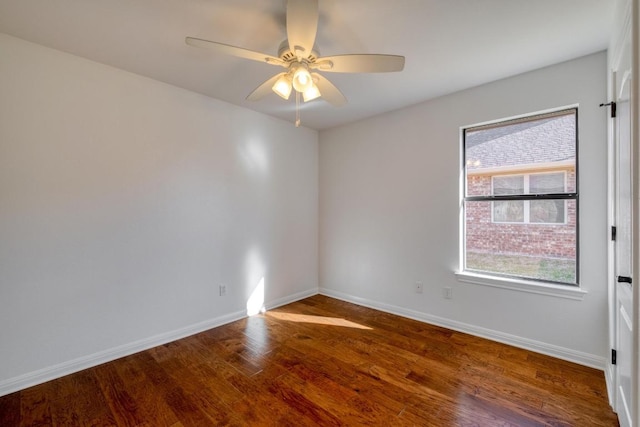 unfurnished room featuring a ceiling fan, baseboards, and wood finished floors