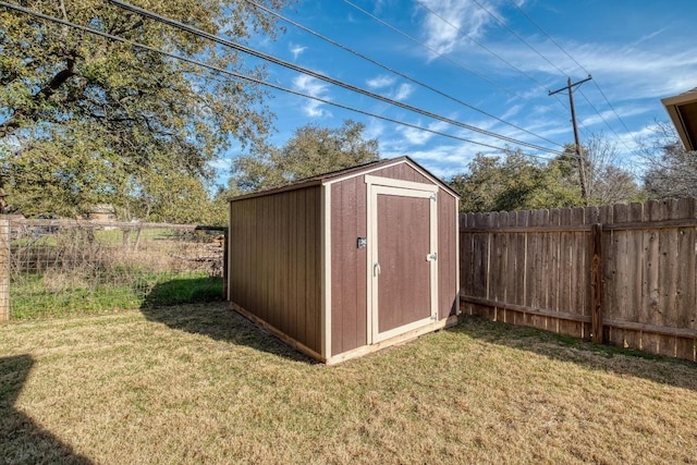 view of shed featuring fence