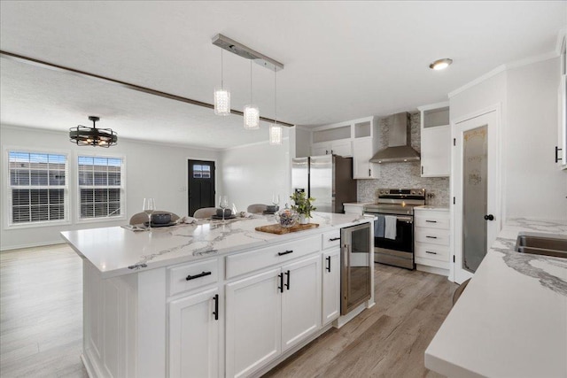 kitchen featuring tasteful backsplash, a center island, stainless steel appliances, wine cooler, and wall chimney range hood