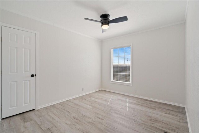 unfurnished room featuring ceiling fan, baseboards, wood finished floors, and ornamental molding