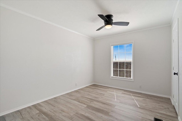 unfurnished room with baseboards, ornamental molding, and light wood finished floors