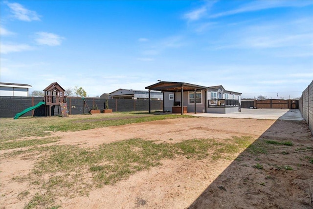 view of yard with a playground and a fenced backyard