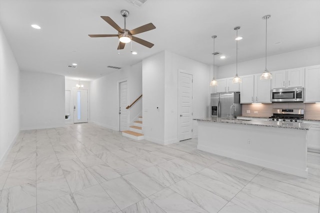 interior space with marble finish floor, a ceiling fan, recessed lighting, baseboards, and stairs