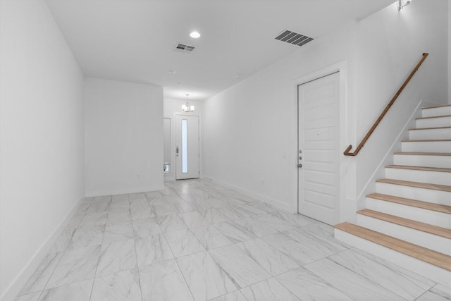 empty room featuring visible vents, marble finish floor, stairs, and baseboards