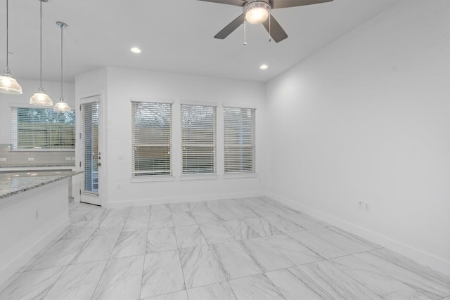 interior space featuring recessed lighting, a ceiling fan, and baseboards