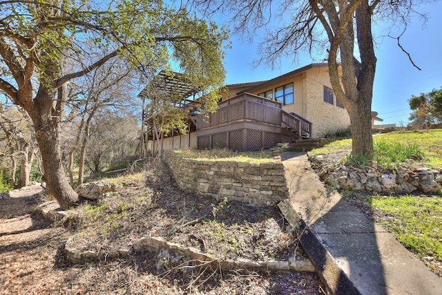 exterior space with a wooden deck and stairway