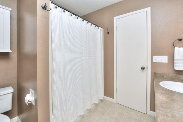 full bathroom with a shower with shower curtain, baseboards, a sink, tile patterned floors, and toilet