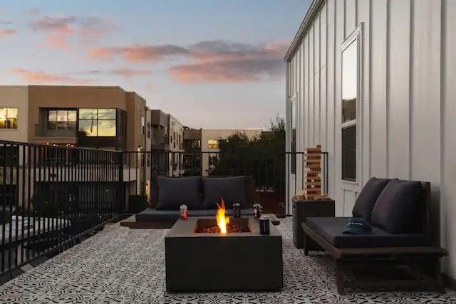 exterior space featuring an outdoor living space with a fire pit and fence