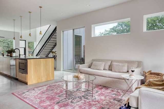 living room with stairway and concrete floors