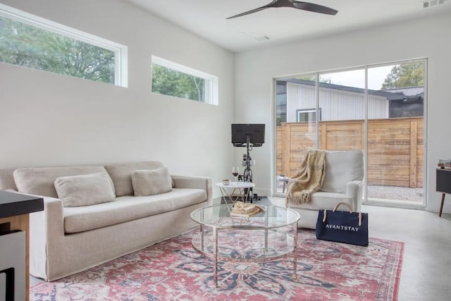 living room featuring visible vents and a ceiling fan