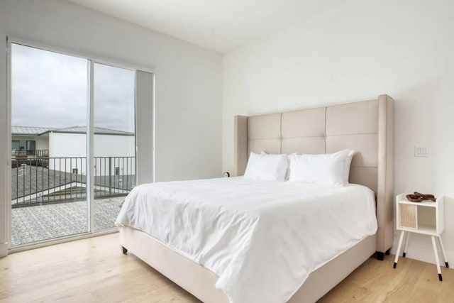 bedroom featuring access to outside and light wood-style flooring