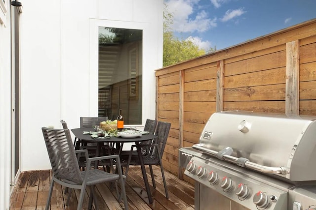 exterior space with a grill and outdoor dining area