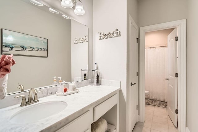 bathroom featuring a shower with curtain, toilet, vanity, and tile patterned flooring