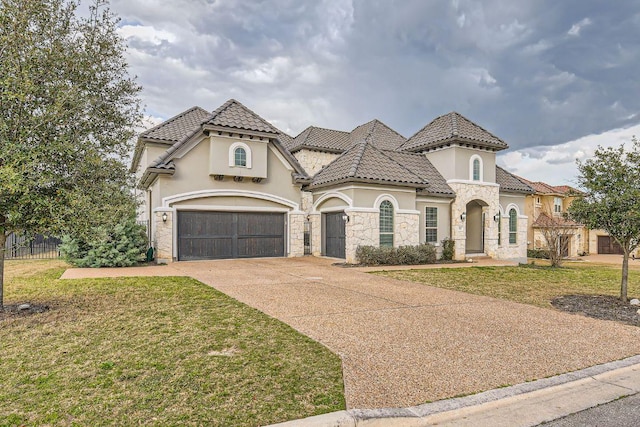 view of front of house featuring stucco siding, concrete driveway, a front yard, and a tile roof