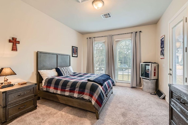 bedroom with visible vents and light colored carpet