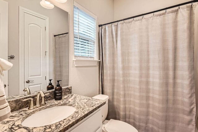 full bathroom featuring toilet and vanity