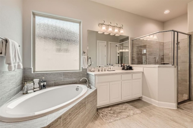 921 Morning Moon Cir, Austin, TX 78732 - full bath featuring vanity, a garden tub, and a stall shower