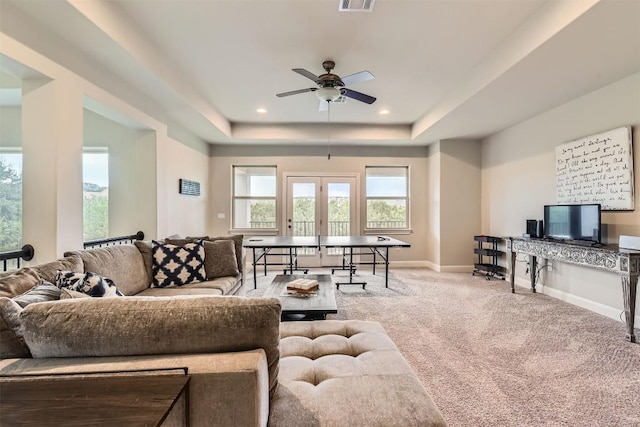 921 Morning Moon Cir, Austin, TX 78732 - living area featuring ceiling fan, a tray ceiling, carpet floors, baseboards, and french doors